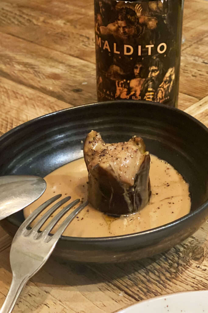 An oven-baked fig filled with foie and a turrón sauce